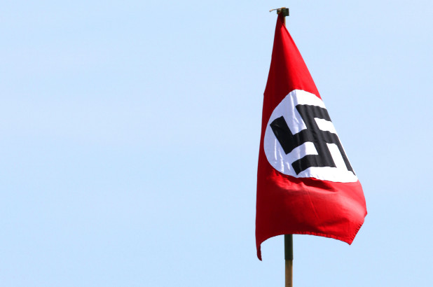 Man refuses to lower Nazi flag flying at home